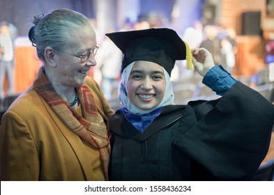 Muslim female student on graduation ceremony with grandmother