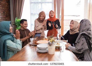 Muslim Friend And Family Laughing Together While Having Lunch Together At Home