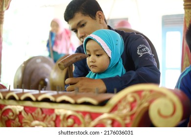 a Muslim girl is learning Gamelan, a musical instrument from Java, Indonesia. 23 June 2019