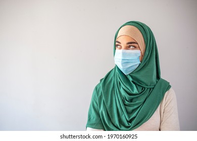 Muslim Girl Wearing Surgical Mask For Protection. Hijab Woman Take A Mask. Beautiful Arab Young Woman With Disposable Face Mask. Protection Versus Viruses And Infection.