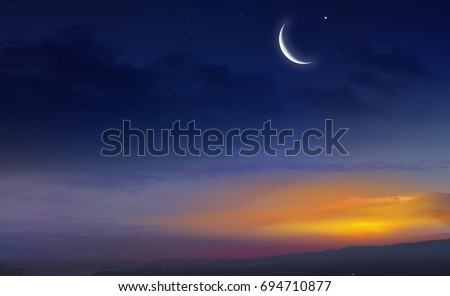 Muslim half moon and beautiful sunset .Sunset over the city . Light in dark sky . beautiful cloud . Ramadan background .  Mubarak background . Prayer time .  Dramatic nature background . Arab night   