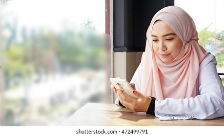 Muslim Hijab Women Using A Smart Phone. 