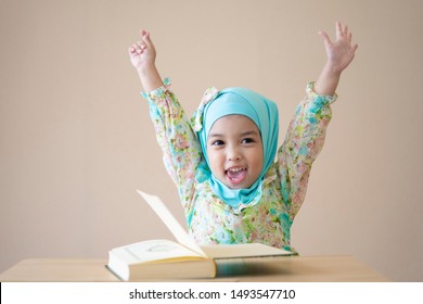 Muslim Kid Raised Up Hands For Celebration After School Time And Finishing The Class. Education Concept.