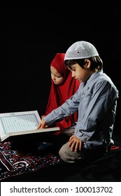 Muslim Kids Reading Holy Koran On  Black Background