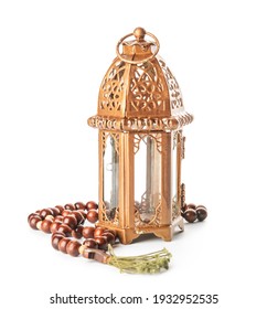 Muslim lamp and tasbih on white background
