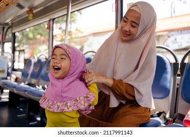 Muslim Little Girl With Hijab Riding Bus Together With Her Mother