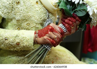 A Muslim Malay Bridal Or Bride Henna Hand Carved Beautiful And Unique Holding Flower. Selective Focus And Shallow DOF