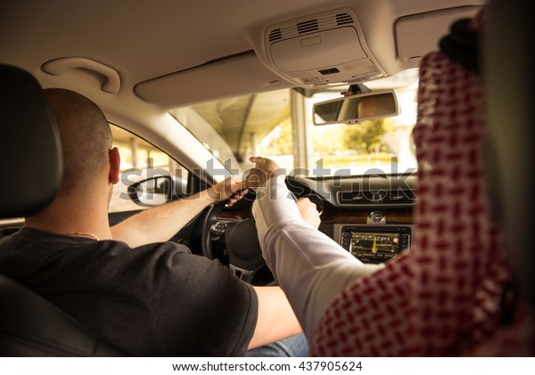 Muslim\
man giving indications a driver where to\
drive.