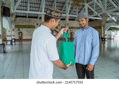 Muslim Man Giving Zakat Charity For Eid Mubarak At The Mosque