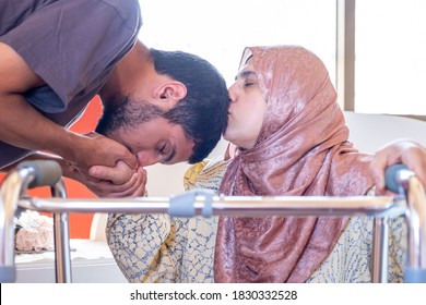 Muslim man is kissing his mother's hand - Powered by Shutterstock