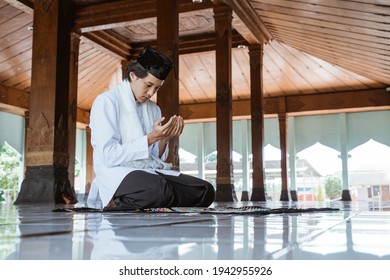 Muslim man kneel down worship and prays for Allah in