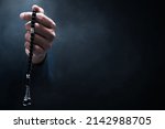 Muslim man praying with rosary beads