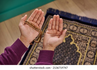 Muslim Man Is Praying, Sitting On Prayer Rug In The Home Concept, Interior, Ramadan, Rosary, Close Up Open Hand, Islam, Ramadan, Friday.