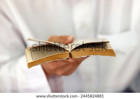 Muslim man reading an Arabic Holy Quran (Koran), Jamiul Azhar Mosque, Vietnam, Indochina, Southeast Asia, Asia
