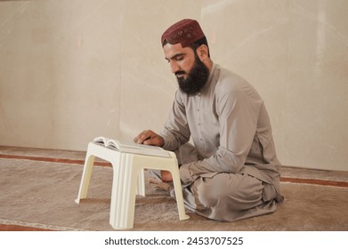 Muslim man reading Quran in mosque - Powered by Shutterstock