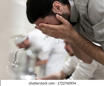 Muslim Man Taking Ablution For Prayer