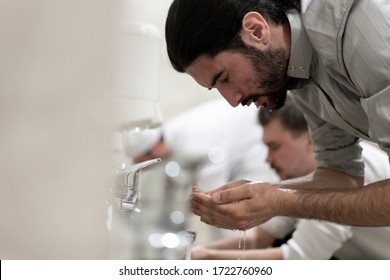 Muslim Man Taking Ablution For Prayer