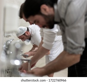 Muslim Man Taking Ablution For Prayer