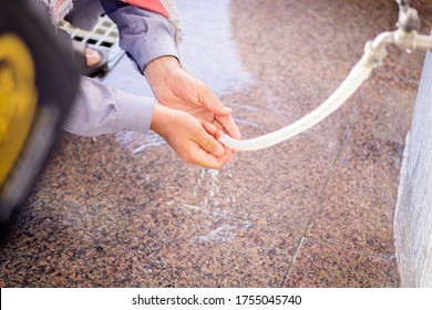 A Muslim Man Taking Wudhu' At Zamzam's Well