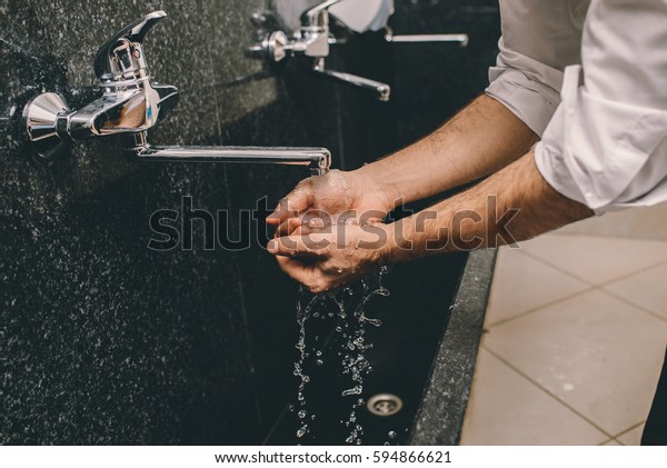 Muslim man washing his\
hands