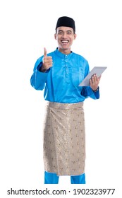 Muslim Melayu Male With Baju Koko Holding Tablet And Show Thumb Up