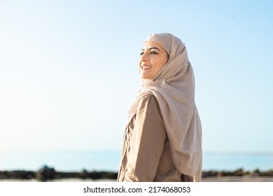 Muslim And Modern Woman Smiling On The Beach With Hope And Happiness