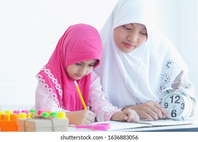 Muslim Mother Or Older Sister Teaches Her Daughter's Homework, With White  Background