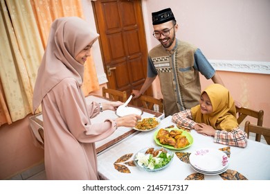 Muslim Mother Serving Some Food For Family Dinner