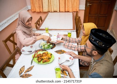 Muslim Mother Serving Some Food For Family Dinner