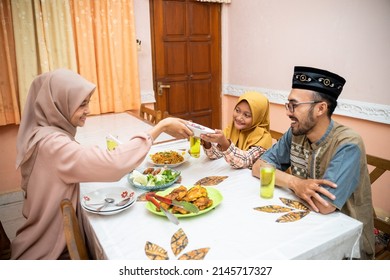 Muslim Mother Serving Some Food For Family Dinner