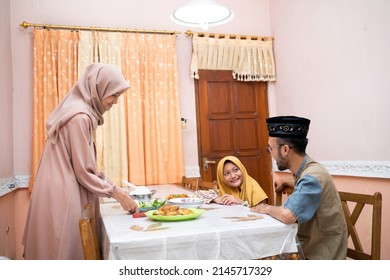 Muslim Mother Serving Some Food For Family Dinner