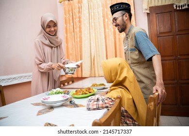 Muslim Mother Serving Some Food For Family Dinner