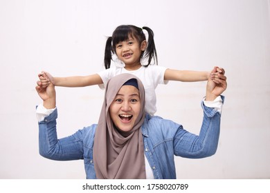 Muslim Mother Wearing Hijab Smiling While Playing With Her Baby Girl, Mom And Daughter Love Each Other, Happy Single Parent