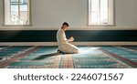 Muslim pray, hope or hands in prayer on carpet for peace, gratitude or support to Allah in holy temple or mosque. Trust, Islamic or spiritual person praying to worship God on Ramadan Kareem in Qatar