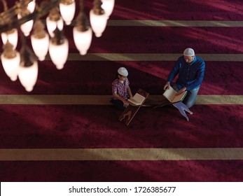 Muslim Prayer Father And Son In Mosque Praying And Reading Holly Book Quran Together Islamic Education Concept