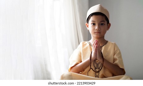 Muslim Pre School Kid Pray To God (Doing  Dua Or Supplication).Concept Of Muslim Kid Praying.