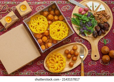 Muslim Ramadan Kareem Festive, Iranian Sweets, Zoolbia, Bamieh, Dates And Walnut And Chees On Wooden Plate And Candles On A Traditional Red Termeh Background, 
 Holy Month Fasting Culture.