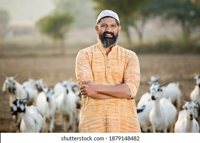 Muslim Shepherd Man With Herd Of Goat On Field