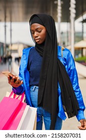 Muslim Shopaholic Browsing Social Media On Street