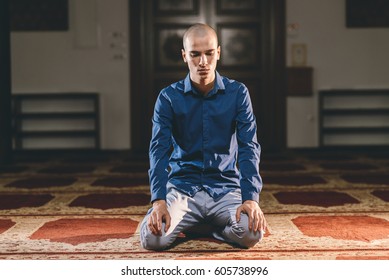 Muslim Teenager Kneeling And Sitting While Praying To God