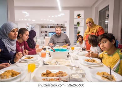 Muslim traditional family together having dinner on table at home