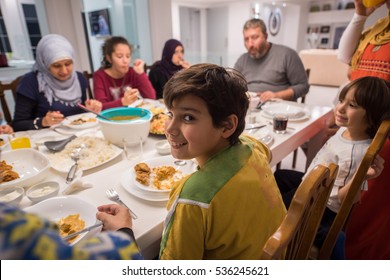 Muslim Traditional Family Together Having Dinner On Table At Home