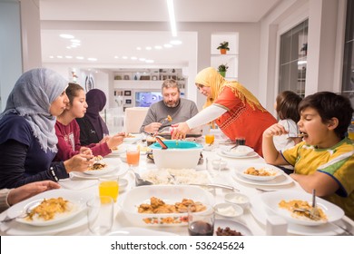 Muslim Traditional Family Together Having Dinner On Table At Home