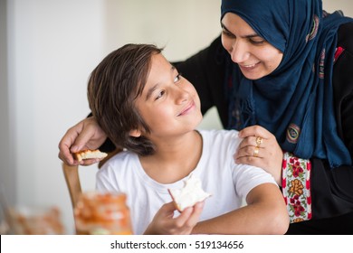 Muslim Traditional Woman With Son At Kitchen