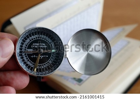 Muslim  using a Qibla compass to indicate the direction of Mecca. Close-Up. 