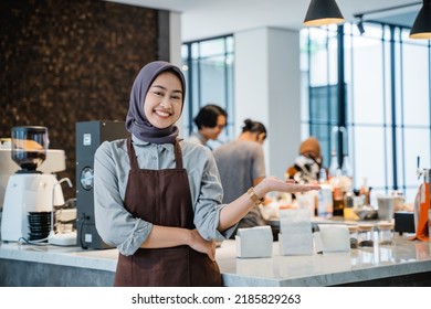 Muslim Waitress Or Owner At Her Coffee Shop Welcoming Customer To Her Newly Open Shop