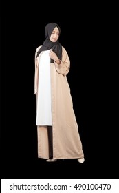 
Muslim woman in a beautiful Islamic dress in full growth, isolated on a black background