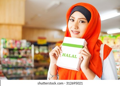 Muslim Woman Buying Halal Food In A Supermarket