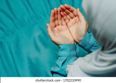 Muslim woman in a headscarf praying (makes a dua)
