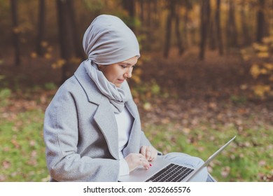 Muslim Woman With Her Laptop In The Park.